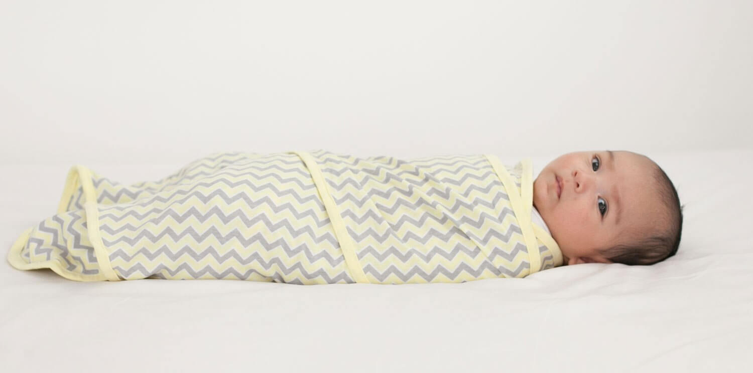 Baby Swaddle patented design to reduce colic and help babies sleep miracleblanket